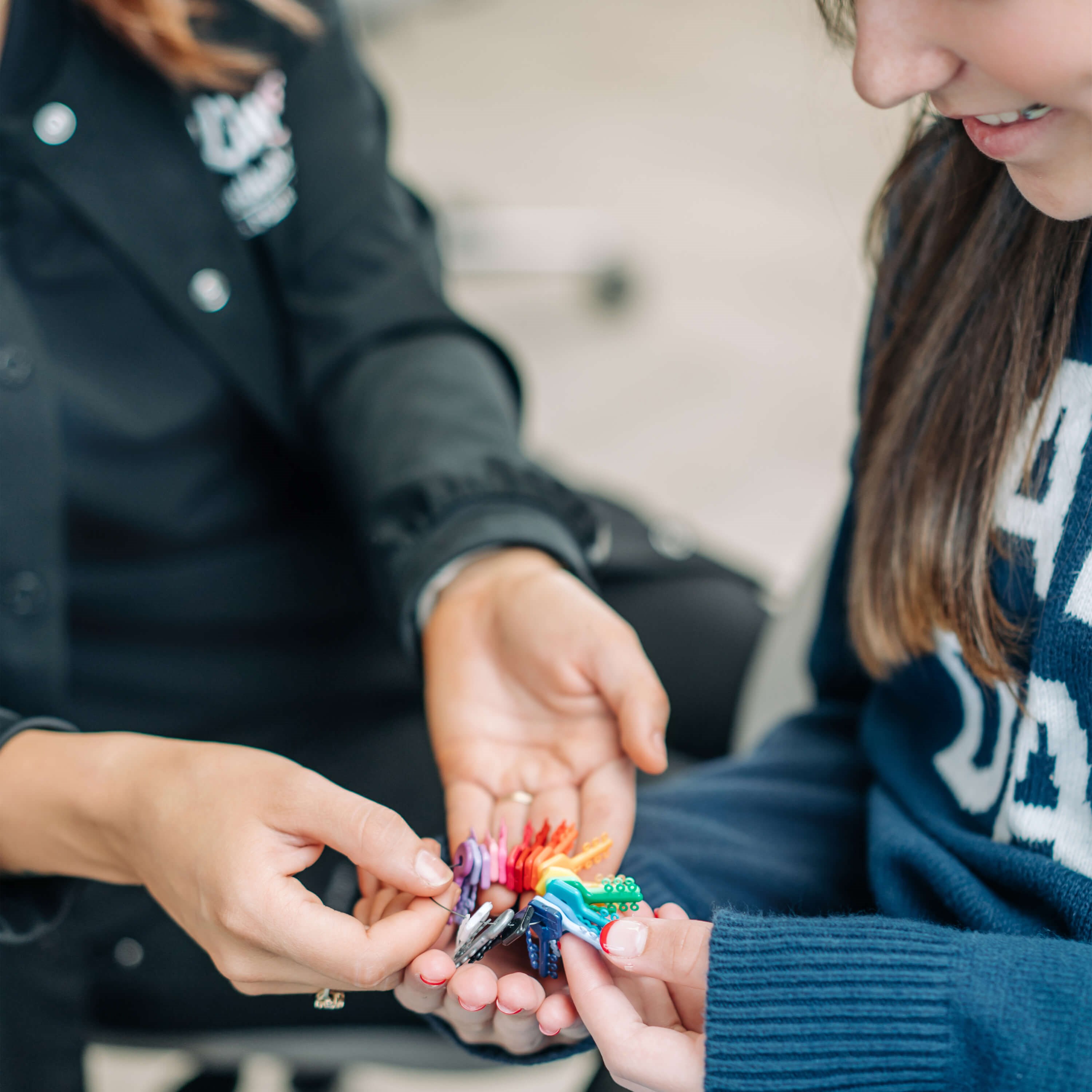 Kingry Orthodontics clinician with young patient, viewing braces tie colors